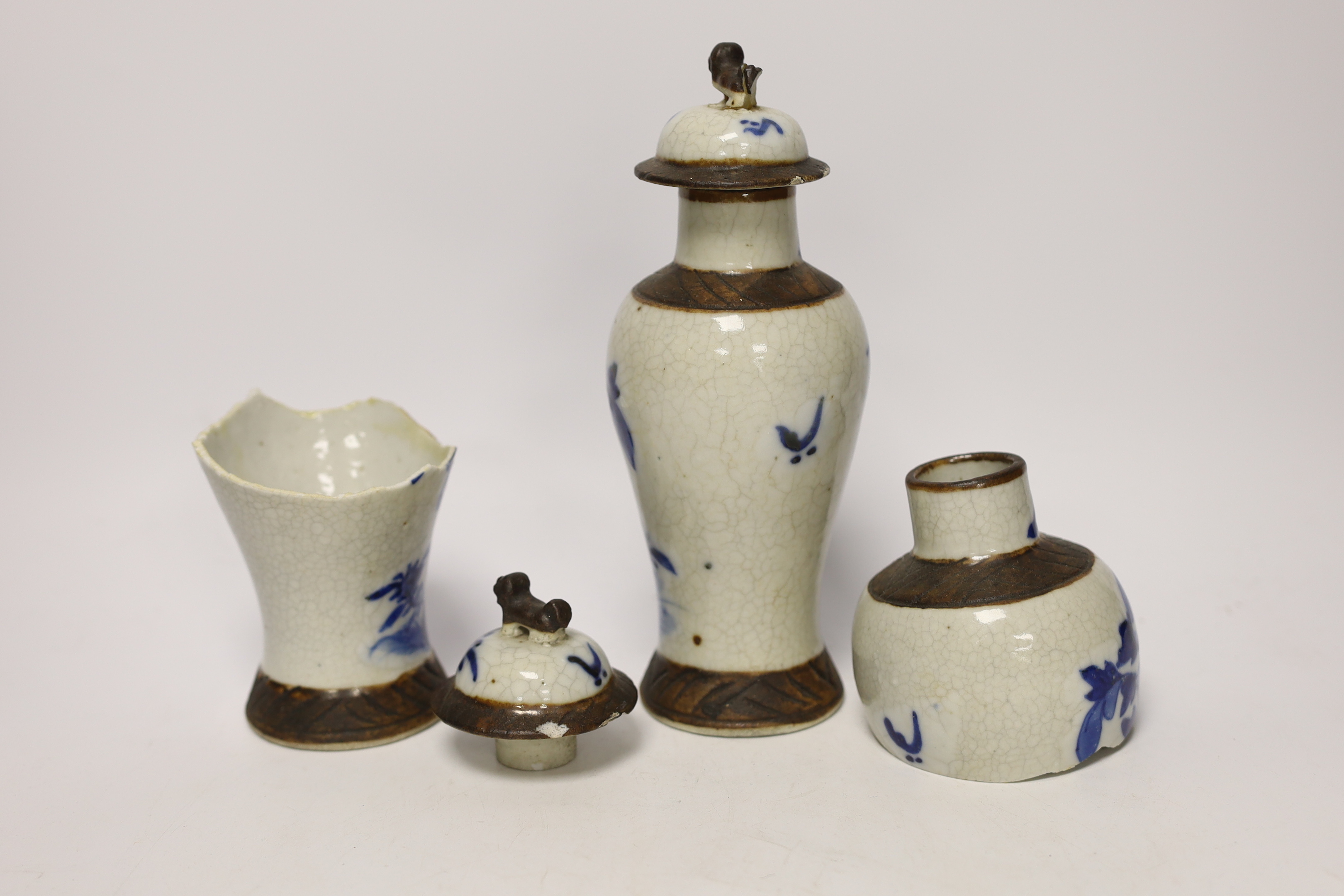 A pair of 19th century Chinese crackleware vases and covers, 15cm high (one badly broken)